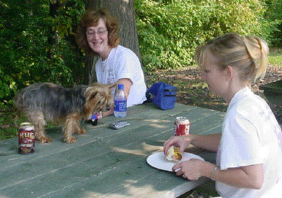 Linda and Tyrine watch Midge stalk a hotdog!