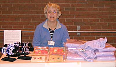Linda sells bracelets she made along with notecards and blankets her sister made!